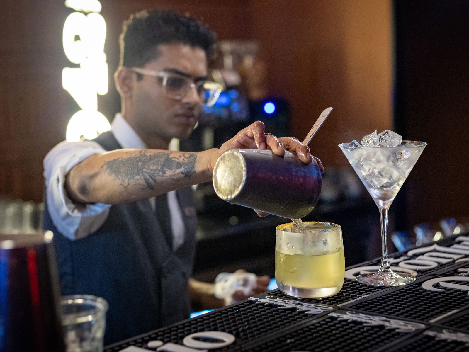 Bartender pouring a cocktail at the Ferrari Night bar